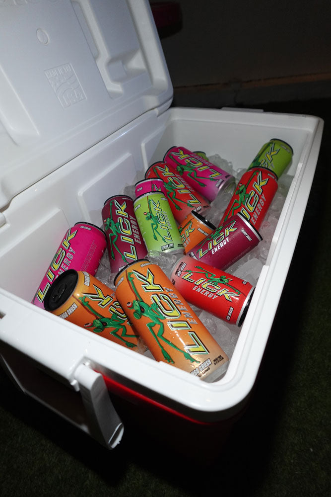Cooler with colorful cans of a popular energy drink brand on ice.